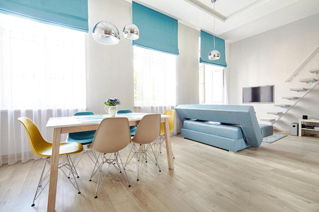 a living room with a table and chairs and a couch at Central Krak Apartments in Krakow