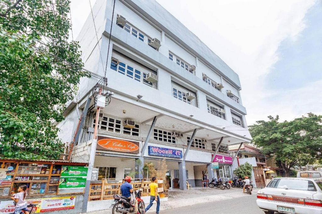 a large white building on the side of a street at RedDoorz near Cebu Metropolitan Cathedral in Adlawon