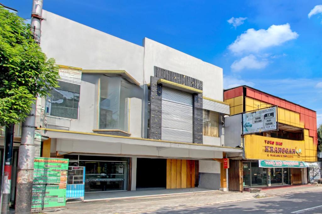 a building on the side of a street at Hotel O Near Tugu Yogyakarta 1 formerly Crown Residence in Jetis