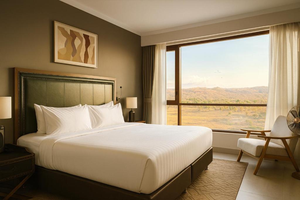 a bedroom with a large bed and a large window at Wellworth Mikumi Wildlife Lodge in Morogoro