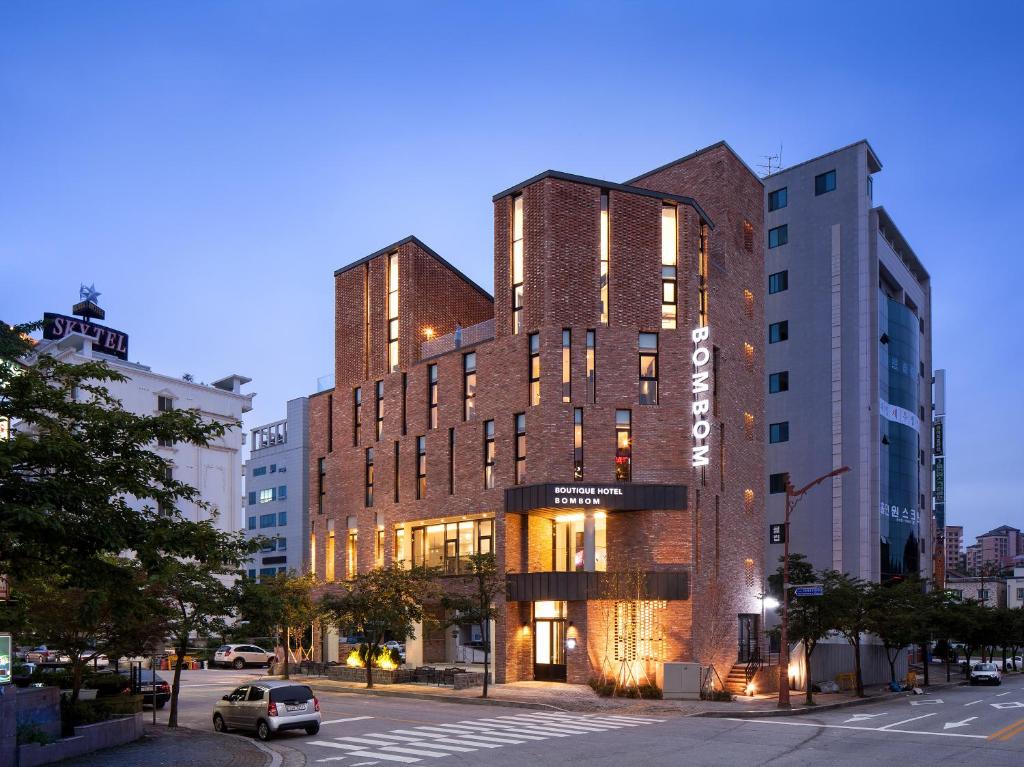 a tall brick building on a city street at Boutique Hotel BomBom in Gangneung