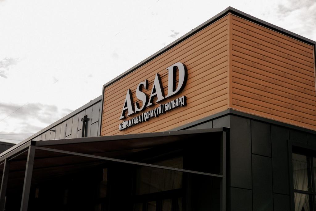 a sign on the side of a building at Asad in Astana