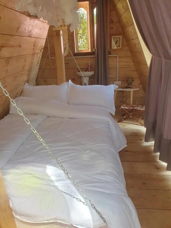 a bed with a chain around it in a room at Mabamba shoebill Campsite in Ziba