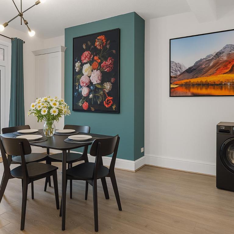 a dining room with a table and a painting of flowers at Harrington Haven 4 Bed Contractor Friendly House with Parking Workington in Workington