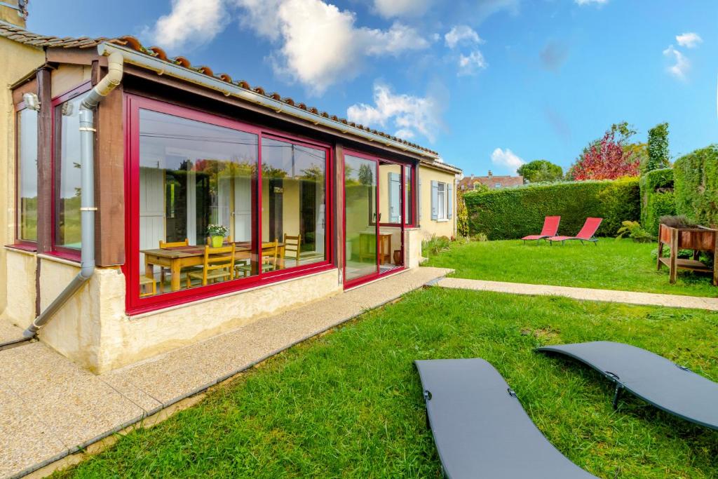 a house with large windows and a yard at La Maison de Reta - House avec piscine privée in Rouffignac Saint-Cernin