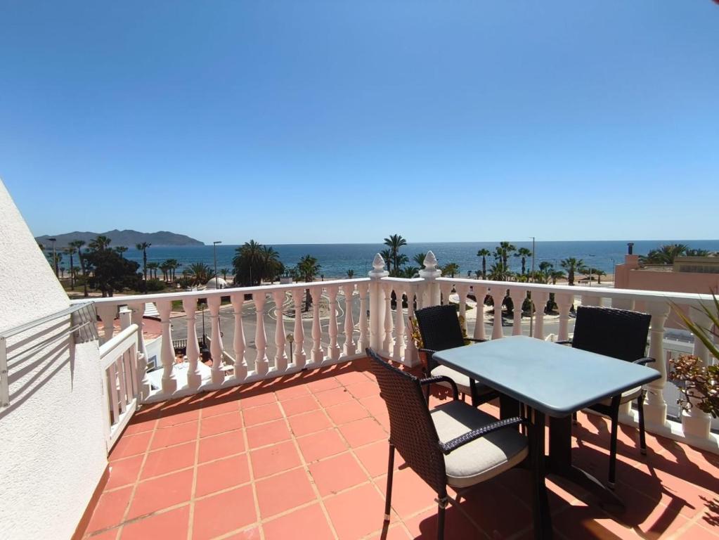 a patio with a table and chairs on a balcony at Apartamentos Bellavista in Puerto de Mazarrón