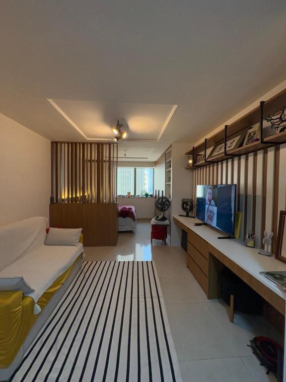 a room with a bed and a tv in it at Estúdio dos sonhos in Rio de Janeiro