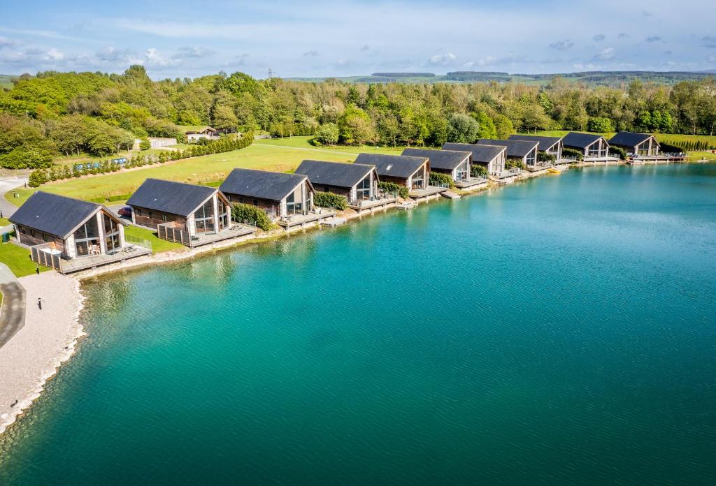 an aerial view of a river with a row of houses at Landal Twin Lakes in Carnforth