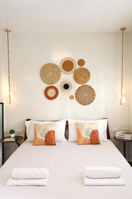 a bedroom with a white bed with pillows at Felicitas Extension Room in General Luna