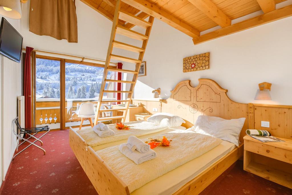 Postel nebo postele na pokoji v ubytování Hotel Relais Alpin