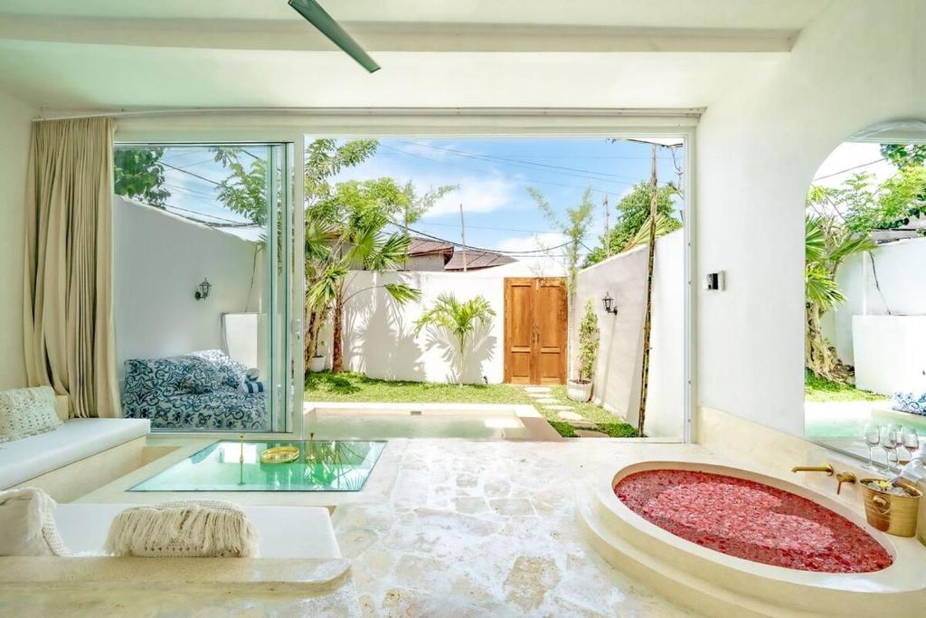 an open living room with a large glass table at Mare 1BR Romantic Villa, 5 Min to Thomas Beach in Uluwatu