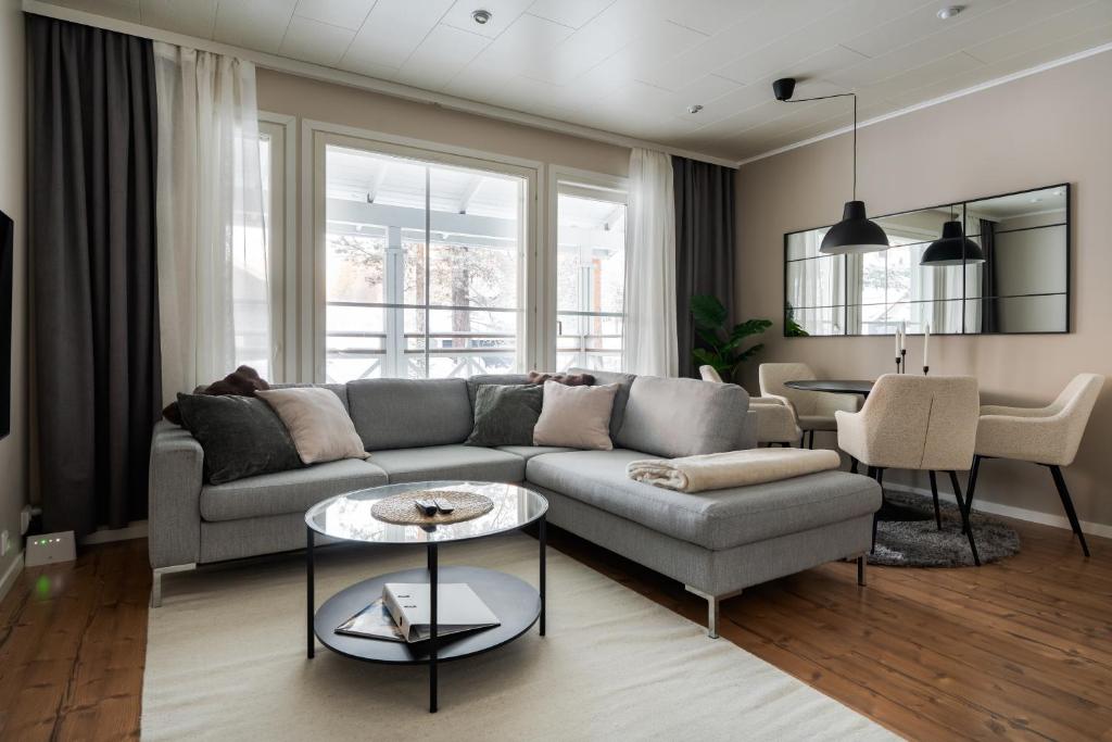 a living room with a couch and a table at Cozy and peaceful holiday apartment in Levi in Levi