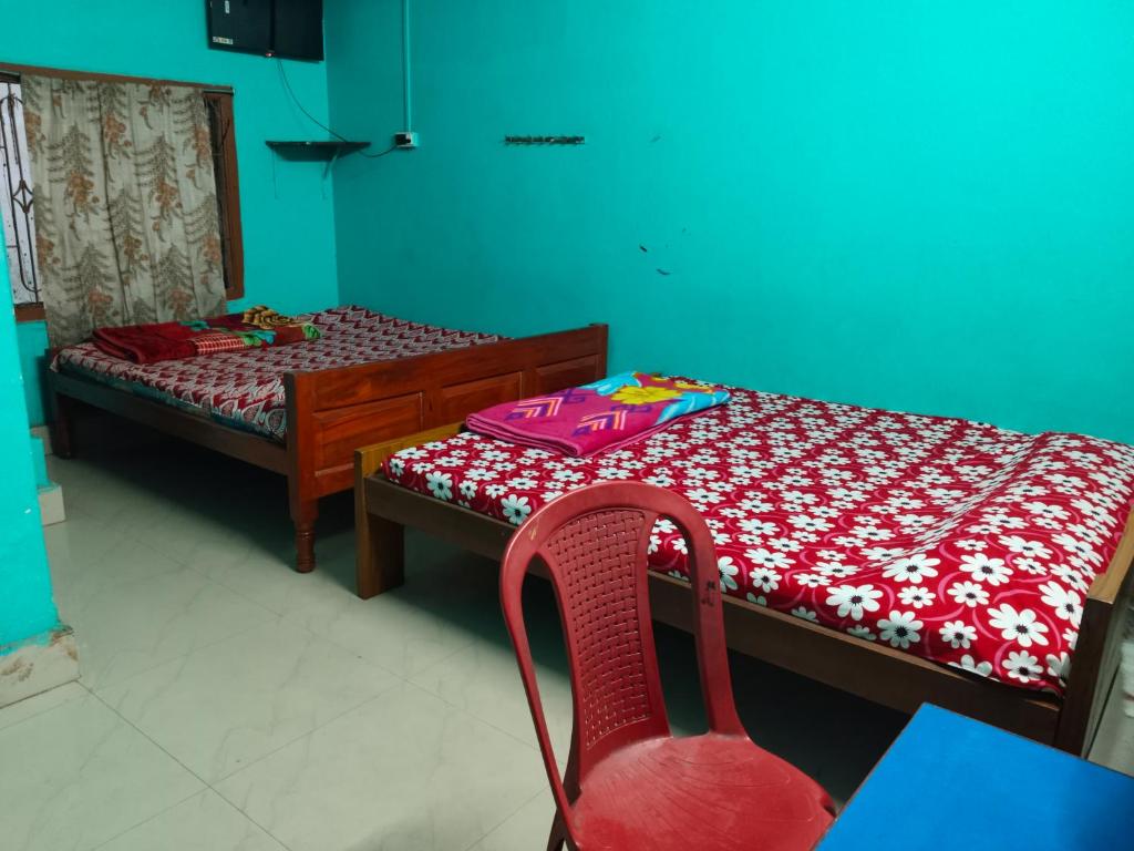 Ένα ή περισσότερα κρεβάτια σε δωμάτιο στο Sarat guest house