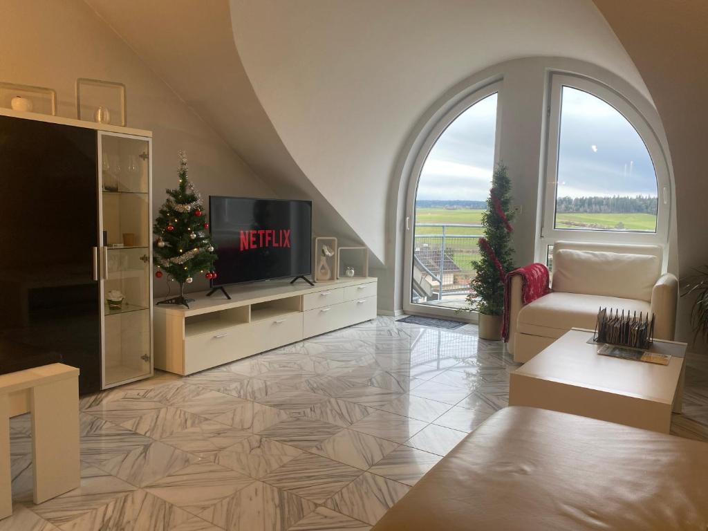 a living room with a television and a christmas tree at Traumurlaub im Schwarzwald in Dornstetten