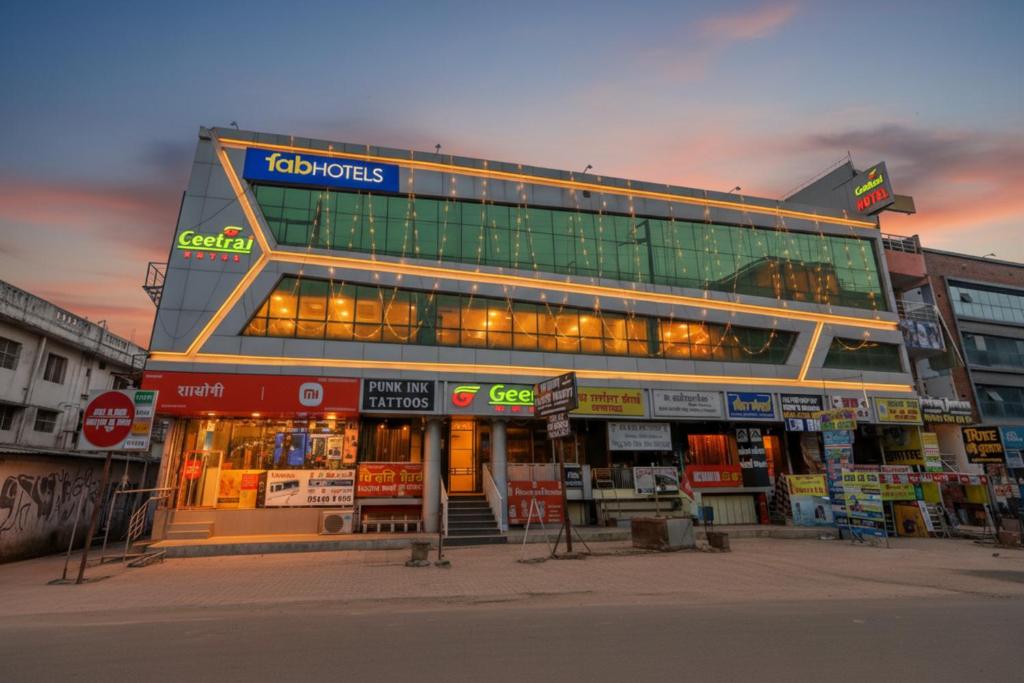 a building with a lot of signs in front of it at FabHotel Geetraj Palace in Lucknow