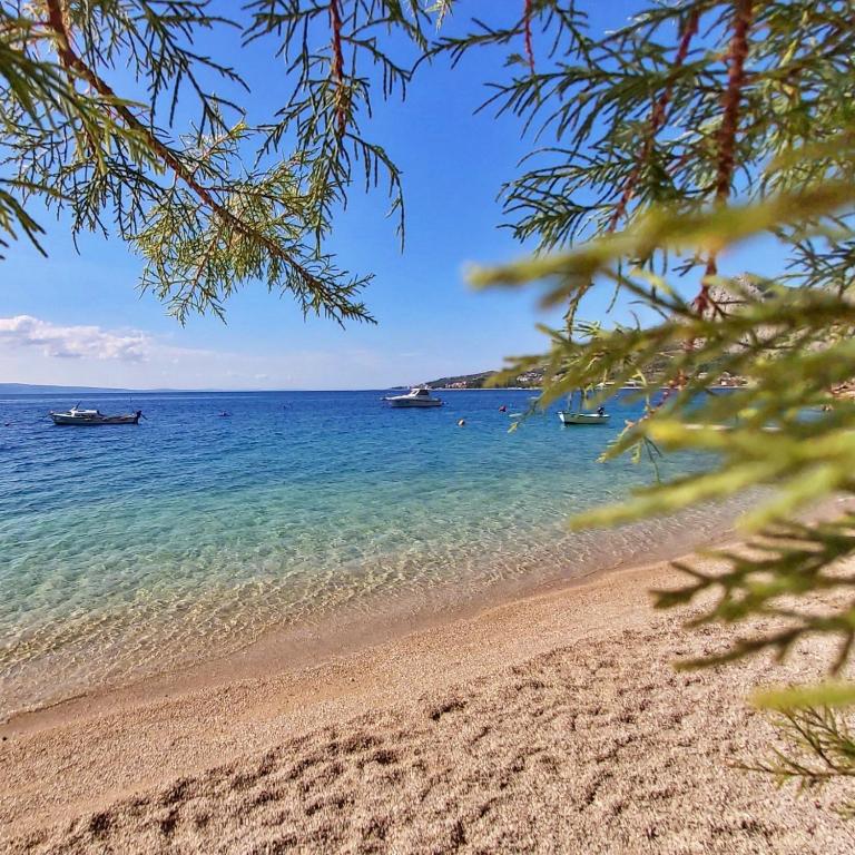 a view of a beach with boats in the water at Apartments Giran in Lokva Rogoznica