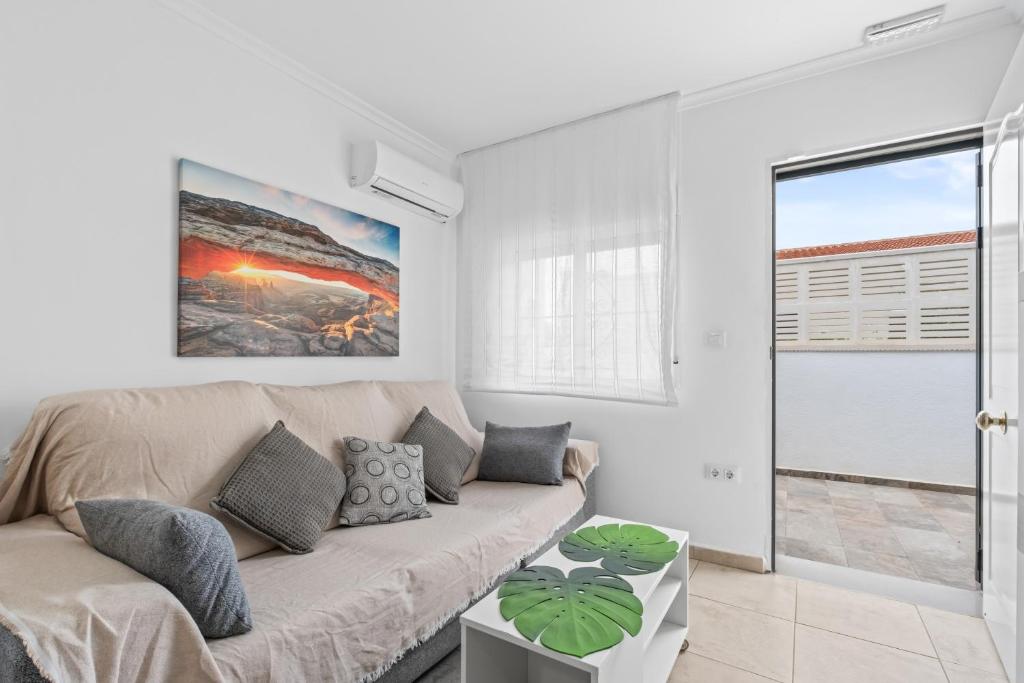 a white living room with a couch and a table at Geani in La Marina