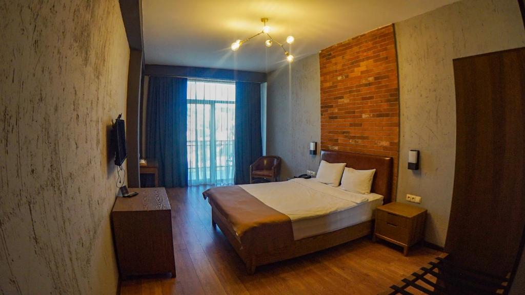 a hotel room with a bed and a window at TM Apart Hotel in Tbilisi City