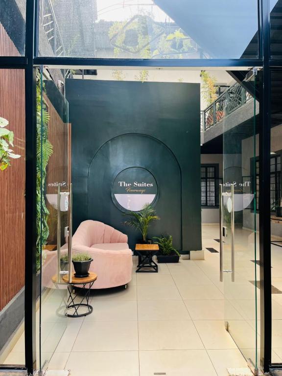 a lobby with a pink couch in a building at The Suites Fourways in Nairobi