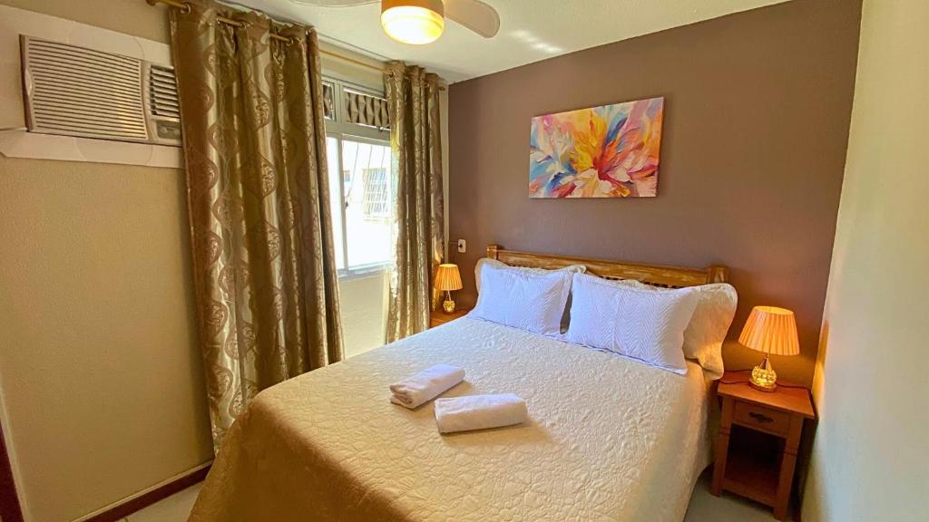 Voodi või voodid majutusasutuse Excelente Apartamento Climatizado em Jacaraipe toas