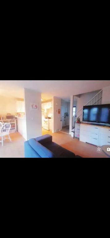 a large living room with a couch and a kitchen at greenview mck sunny room in Calgary
