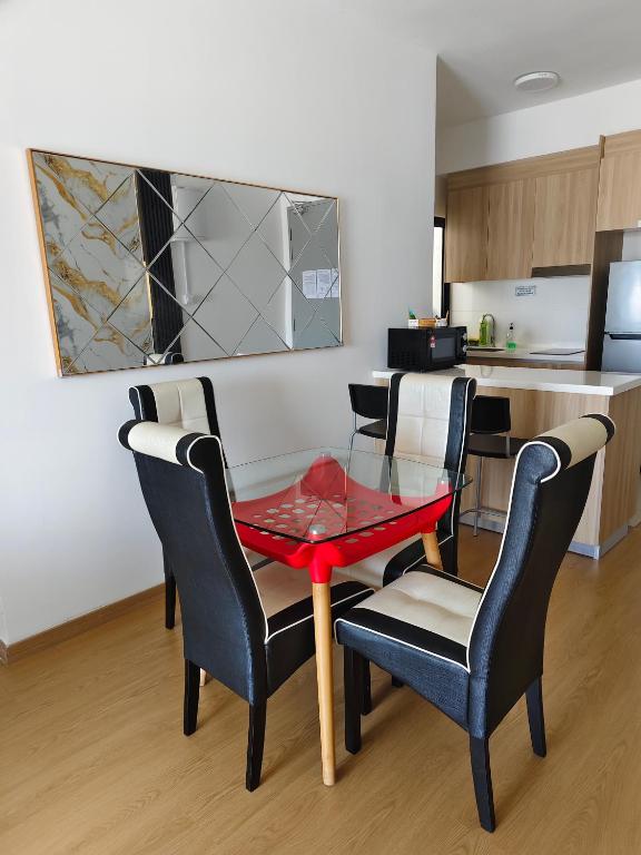 a room with a table and chairs and a kitchen at Maya Bay Residence Splashmania Gamuda Cove in Banting