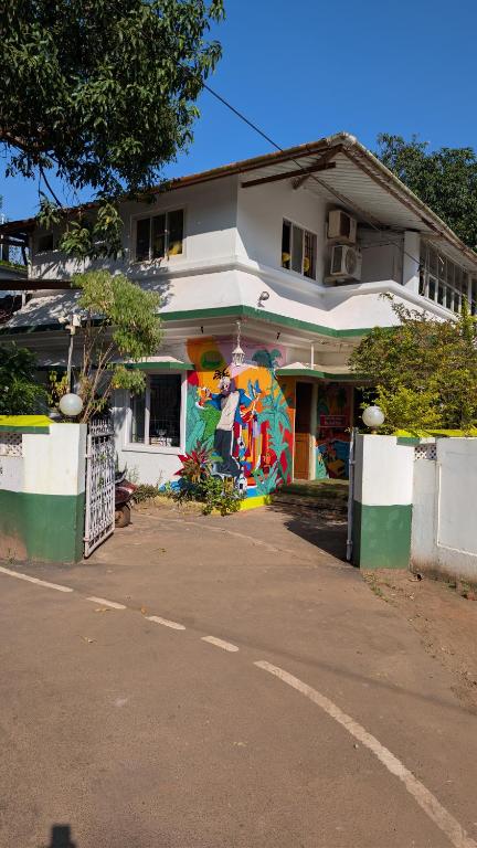 a building with a mural on the side of it at Jungle Hostel by Mango Tree in Vagator