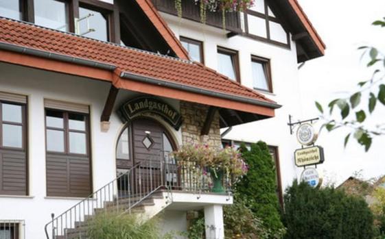 HeubachLandgasthof Rhönsicht的带有阳台并种有鲜花的建筑