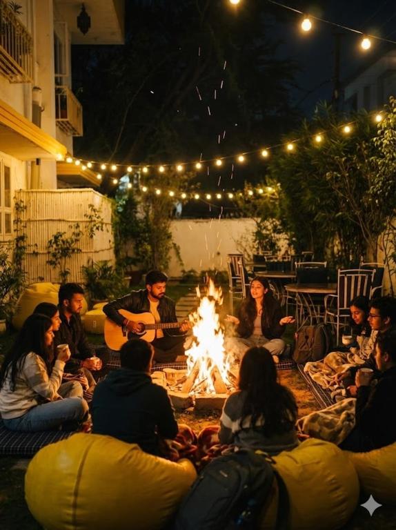 a group of people sitting around a fire at night at J Startup House - Coliving & Coworking, Jaipur - C Scheme in Jaipur