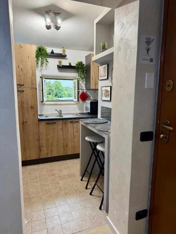 a kitchen with a counter and a sink and a window at Dea Bendata HERMES in Palestrina