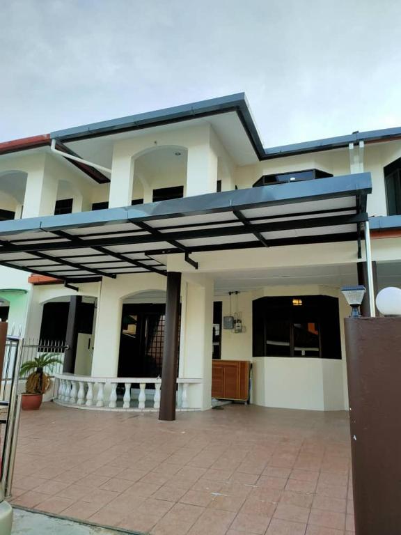 a house with awning in front of it at HANNI HomeStay in Sibu