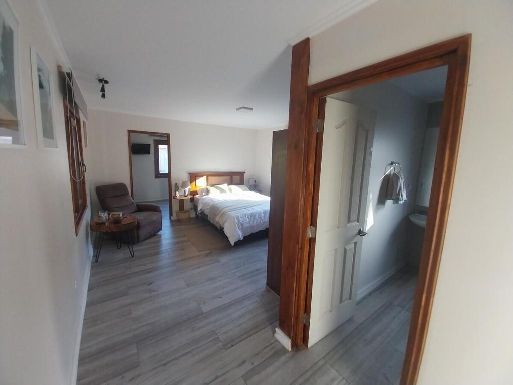 a room with a bed and a door leading to a bedroom at Refugio de montaña in El Manzano