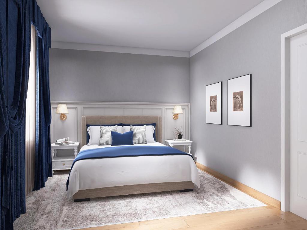 a bedroom with a king sized bed and blue walls at Hotel Livata Mountain & Wellness in Subiaco