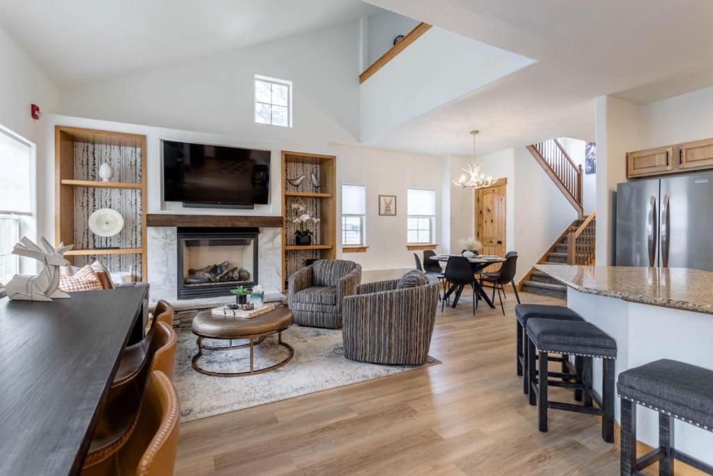 a living room with a kitchen and a living room with a fireplace at 3 BR Fraser Apartment in Fraser