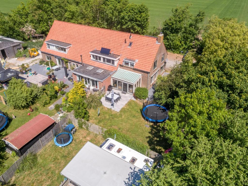 an aerial view of a large house with a yard at Noorderburcht in Oosterend