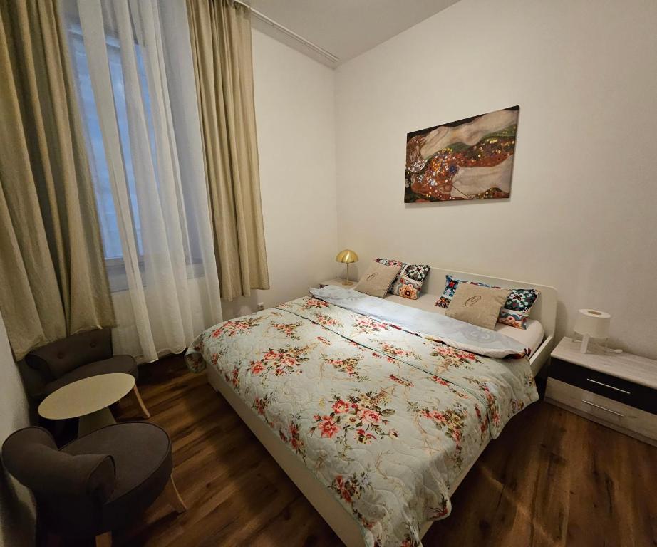 a bedroom with a bed and a chair and a window at Olymp in Bamberg