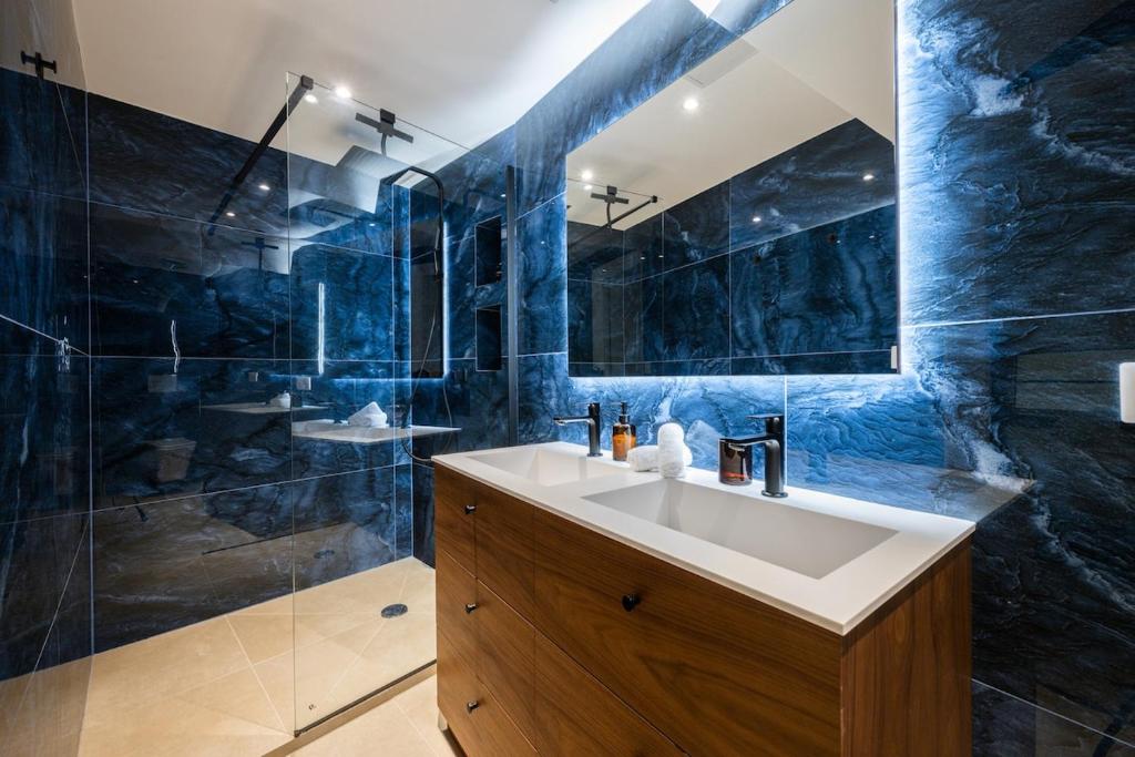 a blue bathroom with a sink and a shower at Duplex Suite Old Town in Antibes