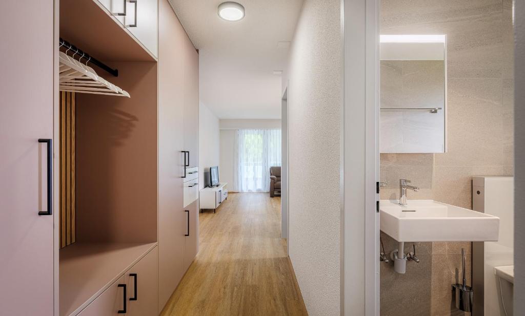 a bathroom with a sink and a mirror at Figaro in Leukerbad