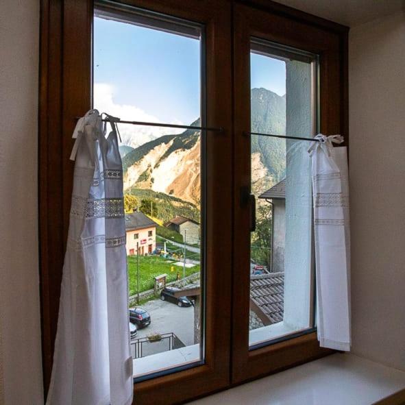 a window with a view of a mountain at Casa Elena in Casso