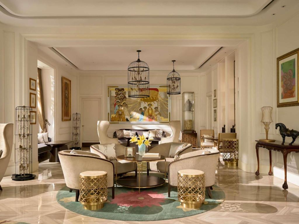 a living room with a couch and a table at Hotel Des Arts Saigon Mgallery Collection in Ho Chi Minh City