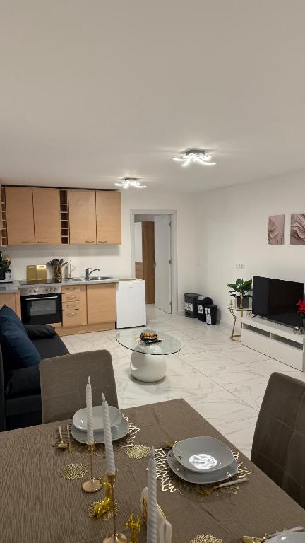 a kitchen and a living room with a table and chairs at Apartment-Alex in Vienna