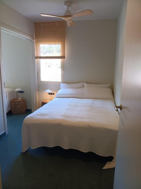 a bedroom with a white bed and a window at Villa D'or in Madrid