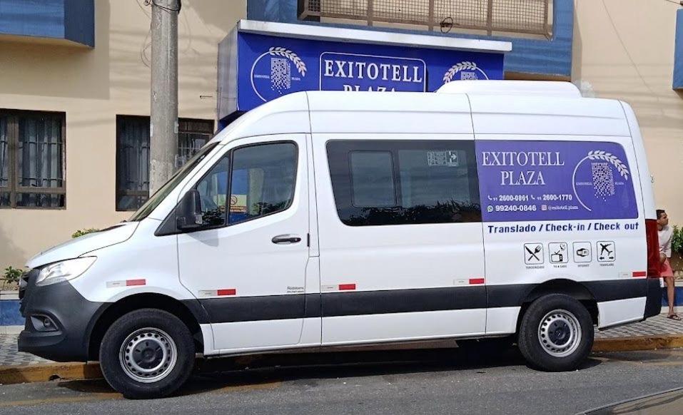 a white van parked in front of a building at Exito in Guarulhos