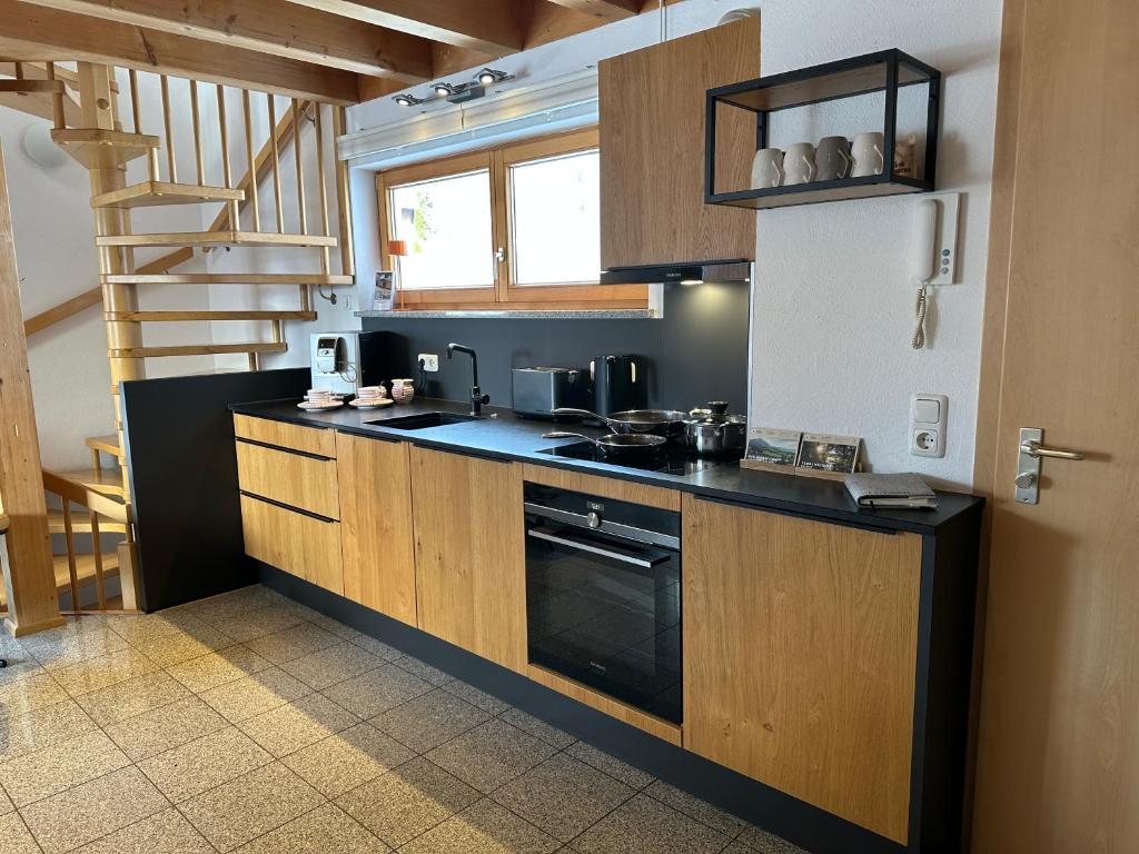 a kitchen with a sink and a stove top oven at Ferienwohnung Richter in Rettenberg