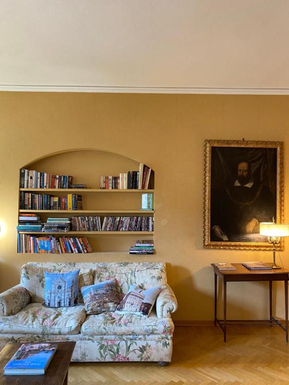 a living room with a couch and a book shelf at Hotel Dali in Florence