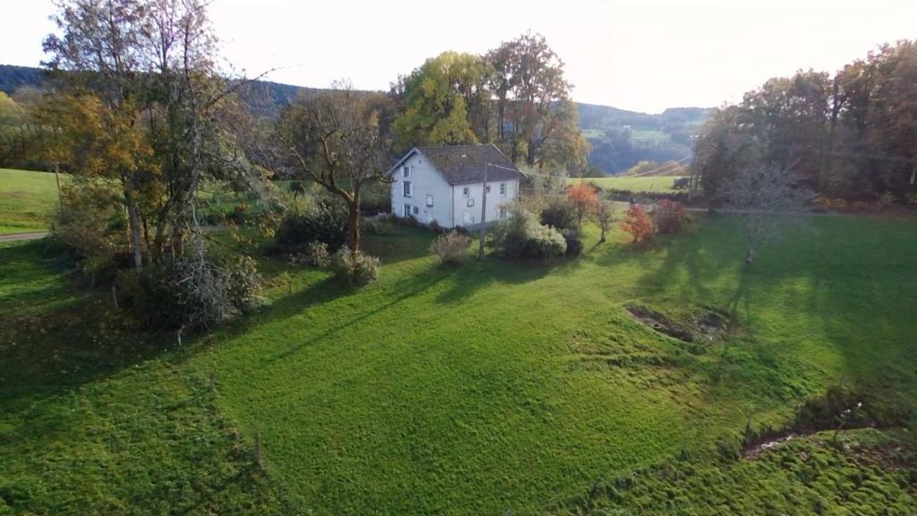 an aerial view of a white house in a field at Le Repaire de la Chouette in Girmont-Val-dʼAjol
