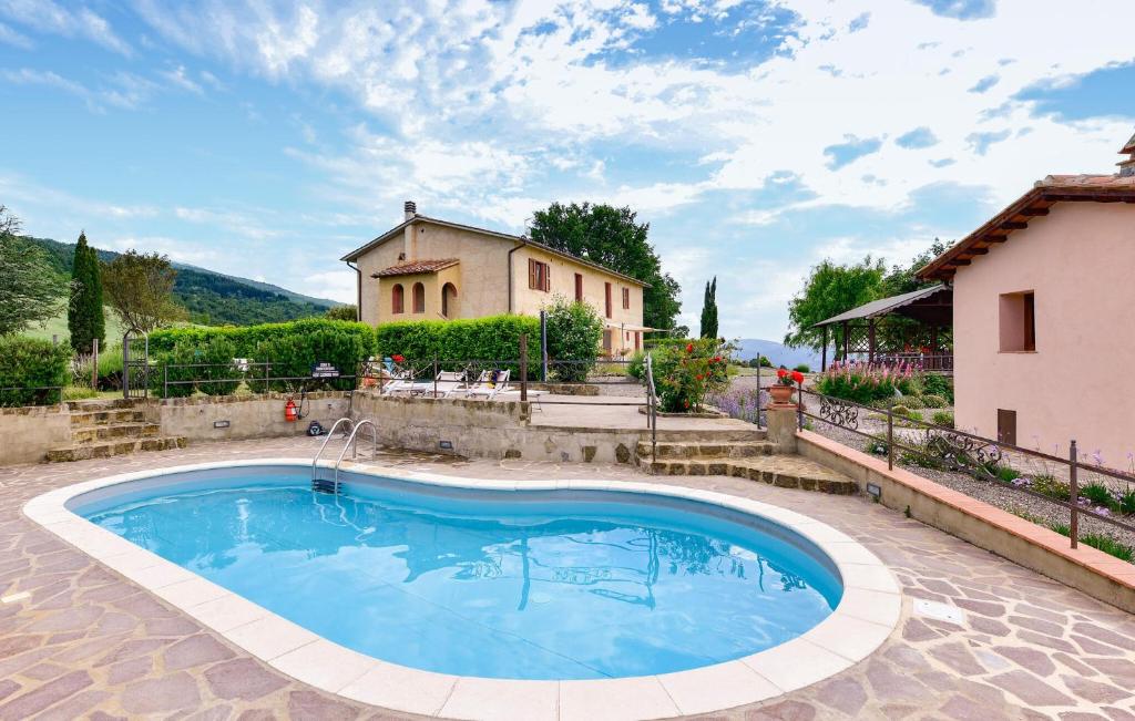 a house with a swimming pool in front of a house at Pet Friendly Home In Pescina in Tepolini