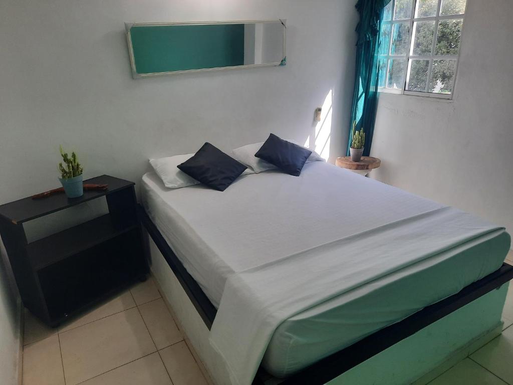 Ένα ή περισσότερα κρεβάτια σε δωμάτιο στο Hostal Santa Maria City