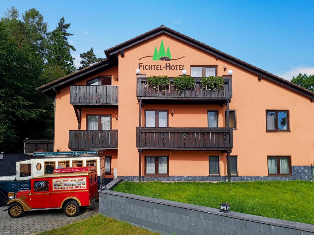a fire truck parked in front of a hotel at Meister BÄR HOTEL Am Wald in Marktredwitz