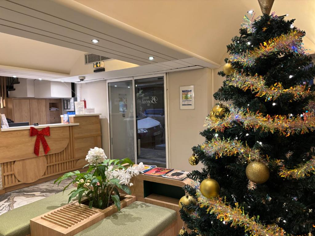 Un árbol de Navidad en una sala de estar junto a una cocina en Hotel Boréal Nice, en Niza